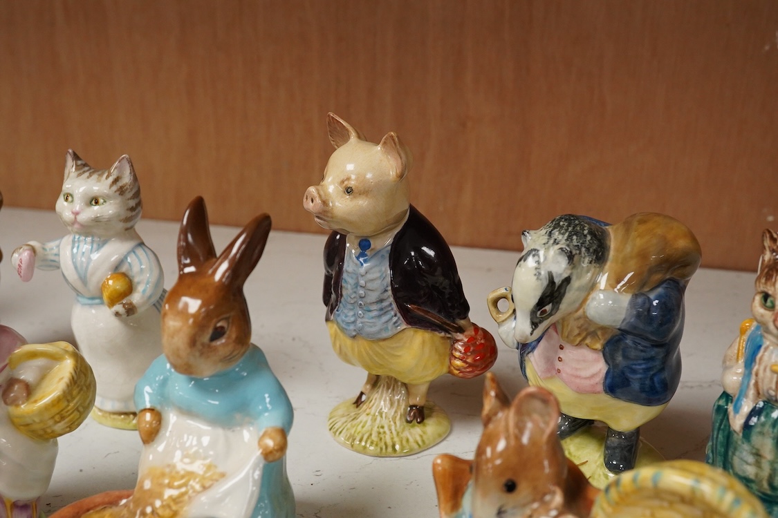 A collection of thirteen Beatrix Potter character figures, stamped with a gold stamp F Warn and Co Ltd, Beswick England, largest 12cm high